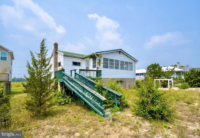 back of house featuring a wooden deck