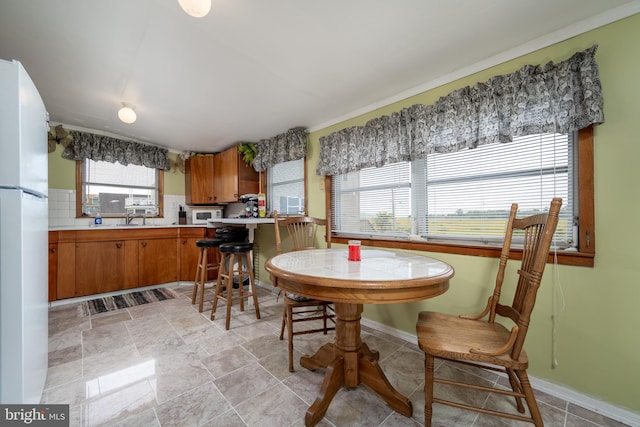 dining room featuring sink and light tile floors