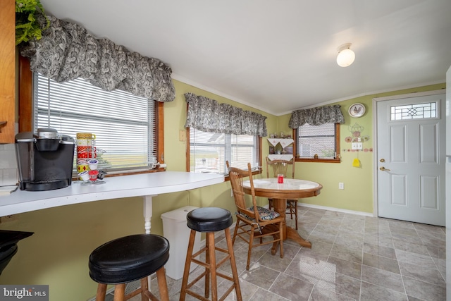 kitchen featuring light tile floors and a breakfast bar area