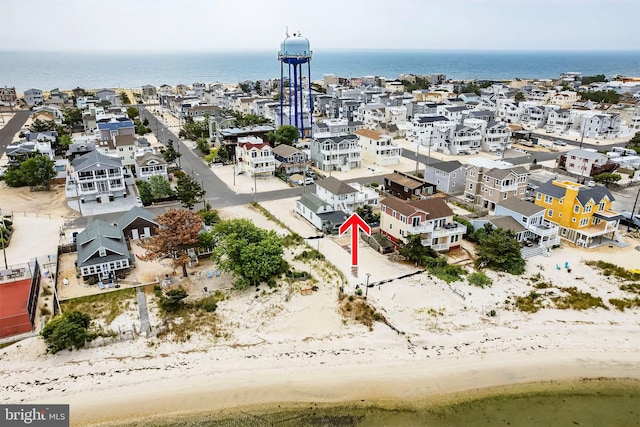 birds eye view of property with a beach view and a water view