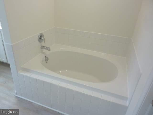 bathroom featuring a relaxing tiled bath