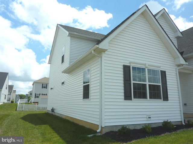 view of side of home featuring a lawn