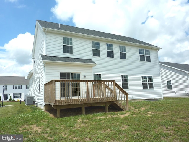 back of house featuring central AC unit, a wooden deck, and a yard