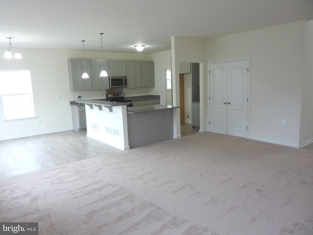 kitchen with a notable chandelier, decorative light fixtures, and light colored carpet