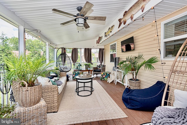 sunroom / solarium with ceiling fan, lofted ceiling, and plenty of natural light