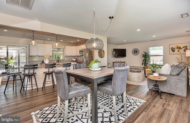 dining room with hardwood / wood-style flooring and sink