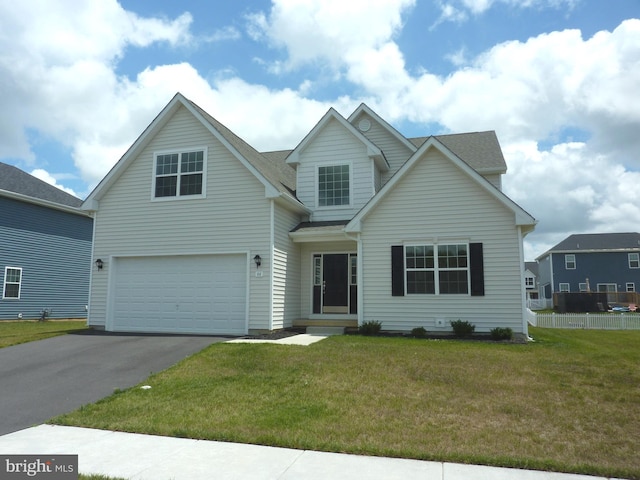 view of front of house featuring a front yard and a garage