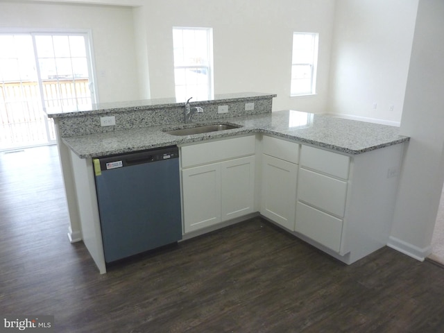 kitchen with dishwasher, white cabinetry, sink, dark hardwood / wood-style floors, and light stone counters