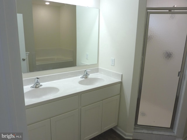 bathroom with independent shower and bath and dual bowl vanity