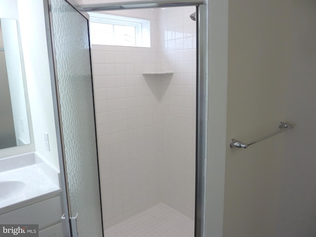 bathroom with tiled shower and oversized vanity