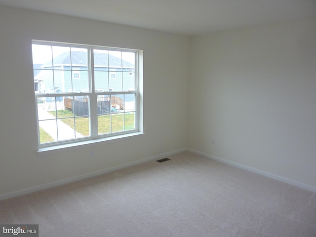 spare room with light colored carpet