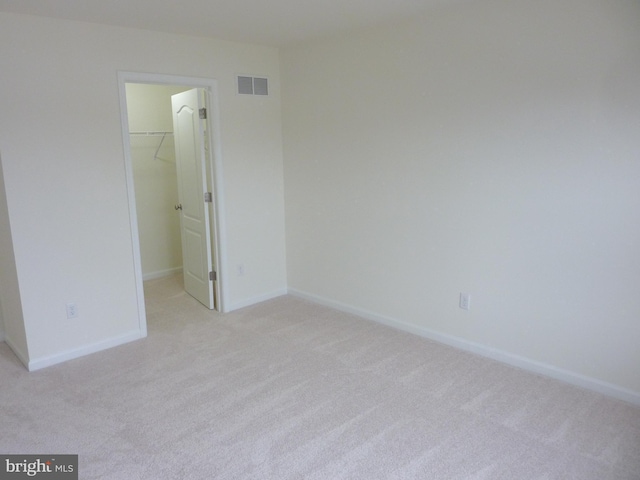 unfurnished room featuring light colored carpet