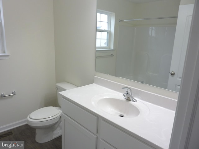 bathroom featuring toilet, hardwood / wood-style floors, and vanity