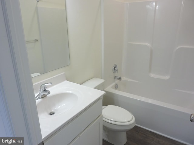 full bathroom featuring toilet, vanity, wood-type flooring, and tub / shower combination