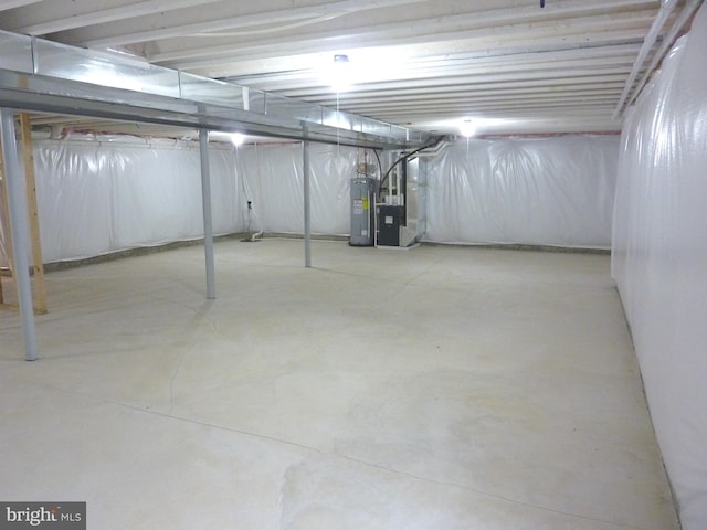 basement featuring electric water heater and heating utilities