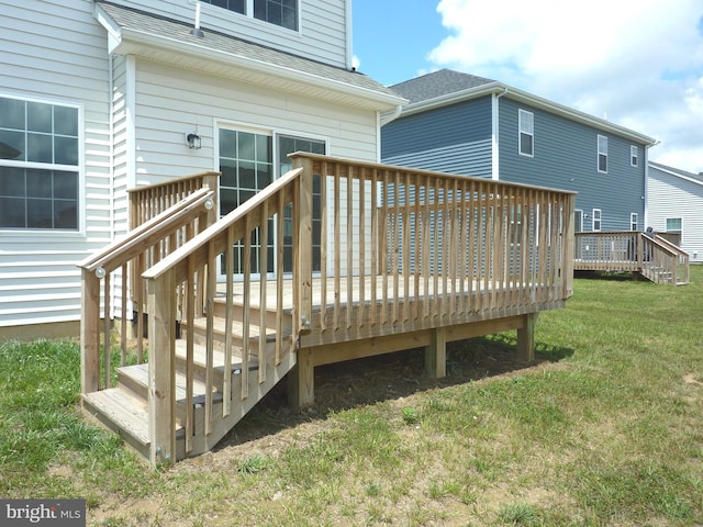 wooden deck featuring a yard