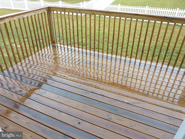 wooden deck featuring a yard