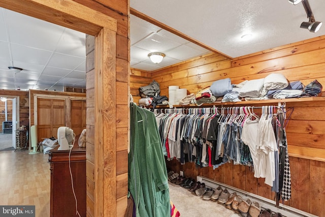 walk in closet featuring a paneled ceiling and light hardwood / wood-style floors