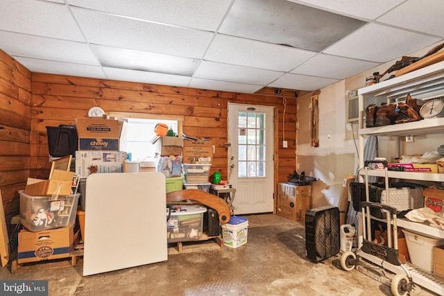 interior space with a drop ceiling and a wealth of natural light