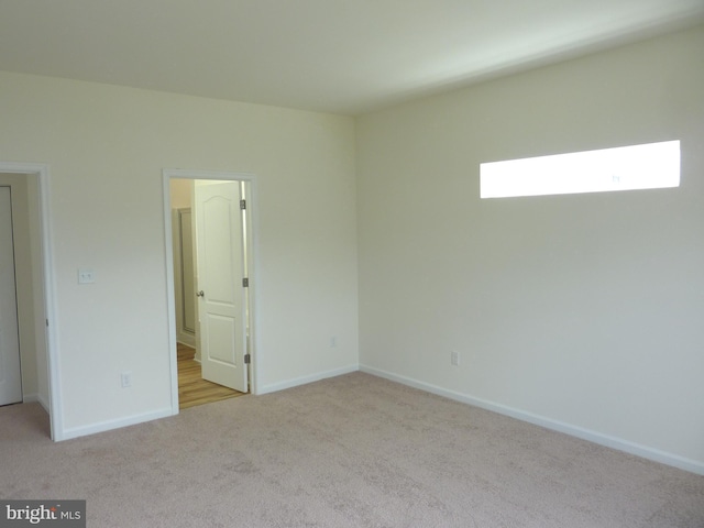 spare room with light carpet