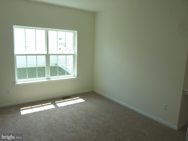 unfurnished room with dark carpet