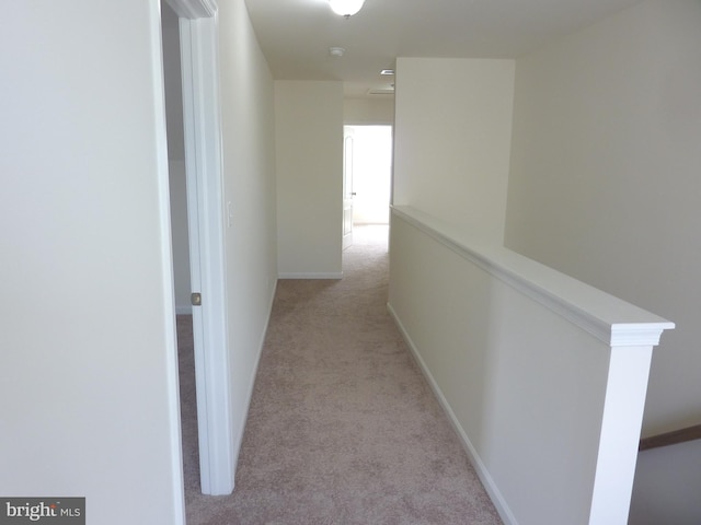 corridor with light colored carpet