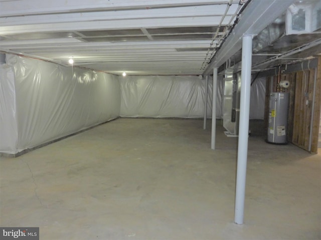 basement featuring water heater and heating utilities