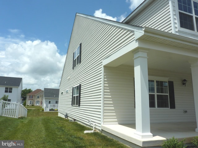 view of side of home with a yard