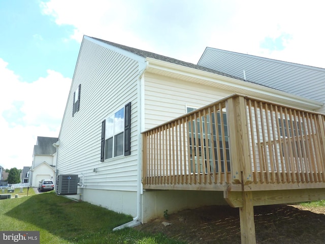 view of side of property with central air condition unit and a wooden deck