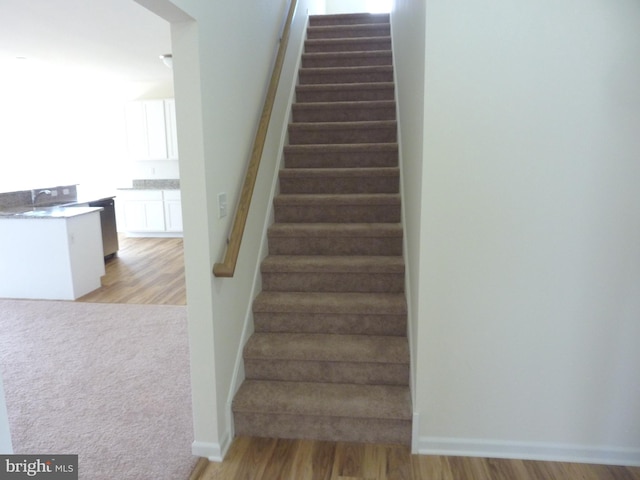 staircase with light hardwood / wood-style flooring