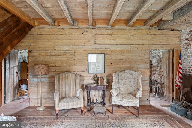 unfurnished room featuring beamed ceiling, wood ceiling, dark wood-type flooring, brick wall, and wooden walls