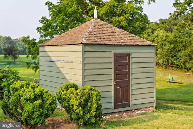 view of outdoor structure featuring a lawn