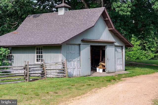 exterior space featuring a lawn and an outdoor structure