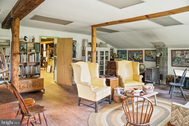 living room featuring a wood stove and vaulted ceiling