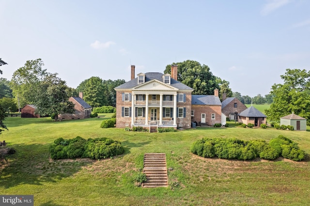 back of house with a yard and a porch