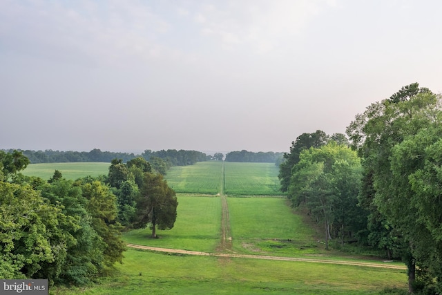 view of home's community with a yard and a rural view