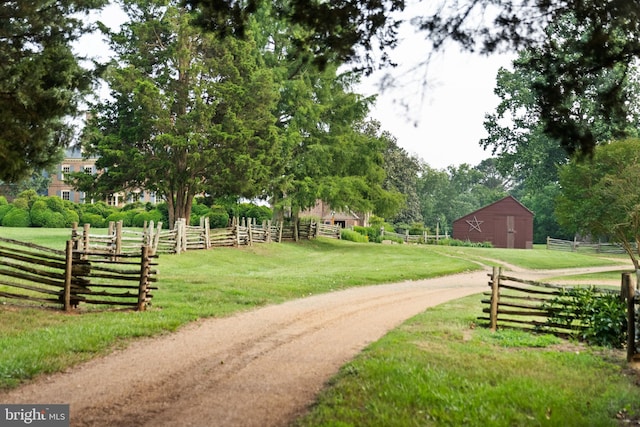 view of property's community with a yard and a rural view