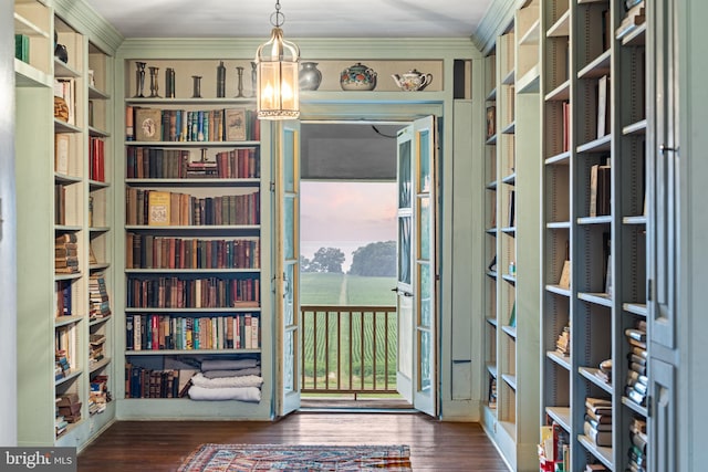 doorway featuring crown molding and dark wood-type flooring