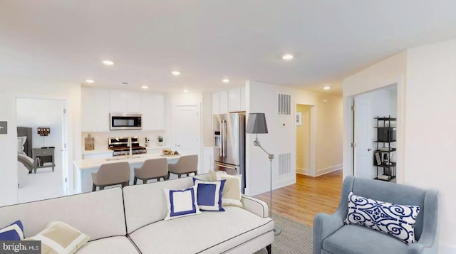 living room with light hardwood / wood-style floors