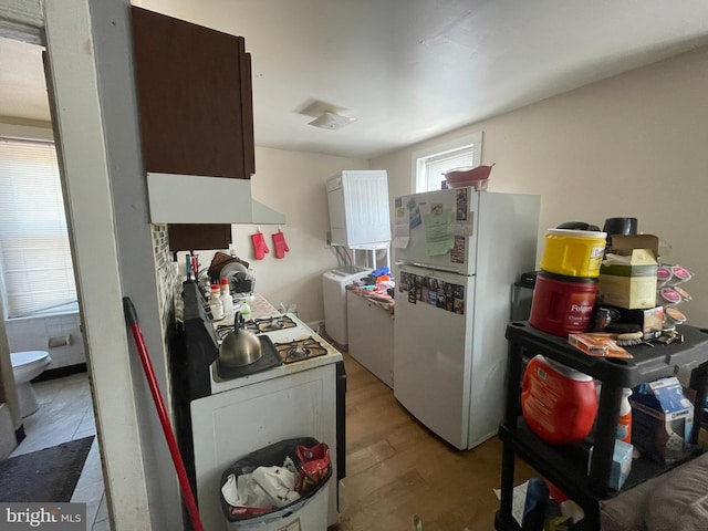 kitchen featuring white appliances and light hardwood / wood-style floors