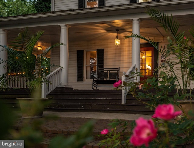 view of exterior entry featuring covered porch