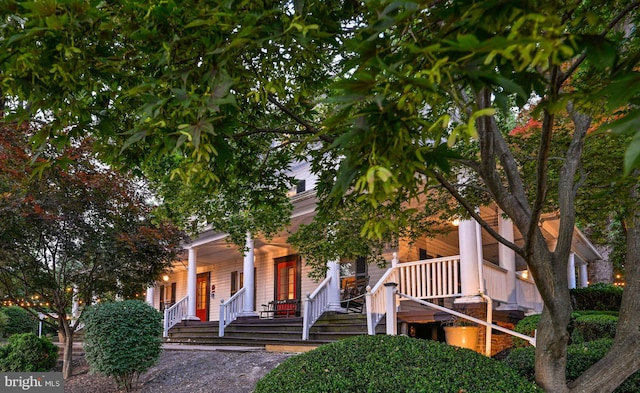 obstructed view of property with covered porch