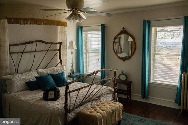 bedroom featuring ceiling fan, ornamental molding, and dark hardwood / wood-style floors