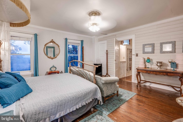 bedroom featuring dark hardwood / wood-style flooring, ceiling fan, connected bathroom, and ornamental molding