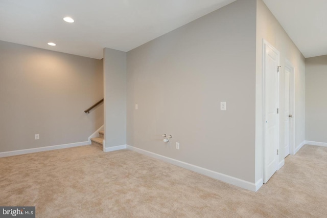 basement featuring light colored carpet