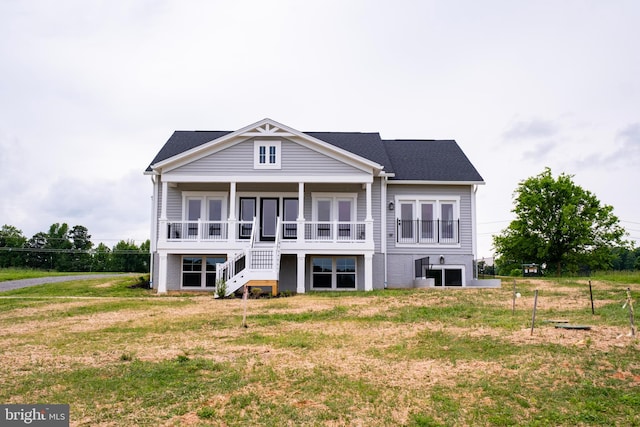 back of property with a lawn