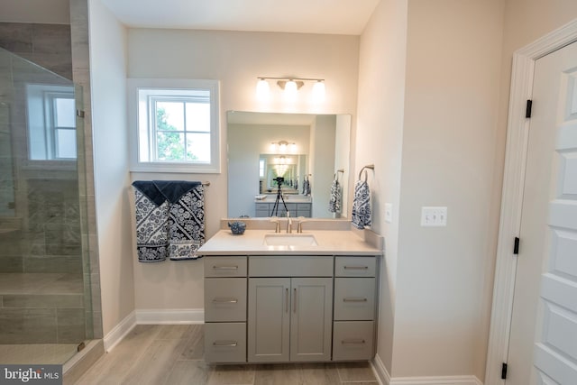 bathroom featuring an enclosed shower and vanity