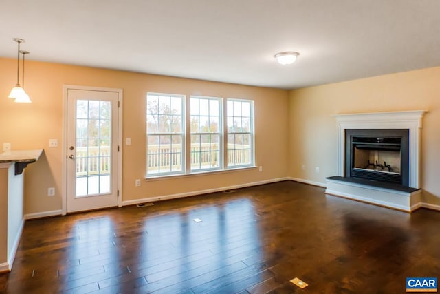 unfurnished living room with dark hardwood / wood-style floors