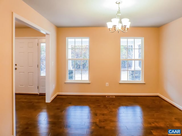 interior space with a chandelier and dark wood-type flooring