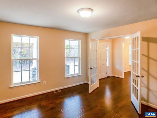 foyer entrance featuring dark hardwood / wood-style floors and french doors